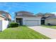 Two-car garage with driveway and neatly landscaped yard at 13419 Lake Monroe Pl, Riverview, FL 33579