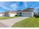 House exterior showcasing a two-car garage and well-maintained lawn at 13419 Lake Monroe Pl, Riverview, FL 33579