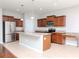 Kitchen with island, stainless steel appliances, and wood cabinets at 13419 Lake Monroe Pl, Riverview, FL 33579