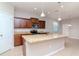 Kitchen with island, stainless steel appliances, and wood cabinets at 13419 Lake Monroe Pl, Riverview, FL 33579