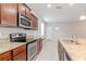 Kitchen features wood cabinets, granite counters, and stainless steel appliances at 13419 Lake Monroe Pl, Riverview, FL 33579