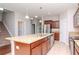 Kitchen with island, stainless steel appliances, and wood cabinets at 13419 Lake Monroe Pl, Riverview, FL 33579