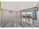 Spacious living room with marble floors and sliding doors to balcony at 1480 Gulf Blvd # 1106, Clearwater Beach, FL 33767