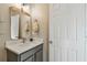 Modern bathroom with gray vanity, mirror, and white countertop at 1753 Montgomery Bell Rd, Wesley Chapel, FL 33543