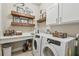 Laundry room with washer, dryer, and custom wooden shelves at 1753 Montgomery Bell Rd, Wesley Chapel, FL 33543