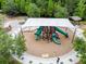 Aerial view of a playground with play structure, shade cover, and surrounding trees at 1753 Montgomery Bell Rd, Wesley Chapel, FL 33543