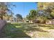 Spacious backyard with mature trees and a large grassy area at 1829 West Dr, Clearwater, FL 33755
