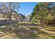 Large backyard with lush landscaping and mature trees at 1829 West Dr, Clearwater, FL 33755