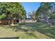Fenced backyard with shed and mature trees at 1829 West Dr, Clearwater, FL 33755