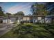 Charming Ranch home with a light green exterior, and nicely landscaped lawn at 1829 West Dr, Clearwater, FL 33755