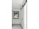 Bright hallway with barn door and window at 1829 West Dr, Clearwater, FL 33755