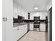 Updated kitchen with white cabinets, granite countertops, and stainless steel appliances at 1829 West Dr, Clearwater, FL 33755