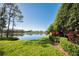 Community lakefront view with lush landscaping and signage at 1929 Northfork Cir, Clearwater, FL 33760