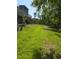 Lush green backyard with mature trees and a grassy area at 3077 Branch, Clearwater, FL 33760