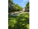 Landscaped backyard with lush green grass and canal view at 3077 Branch, Clearwater, FL 33760