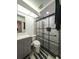 Modern bathroom with gray vanity, frameless shower, and marble tile at 3077 Branch, Clearwater, FL 33760