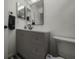 Modern bathroom with gray vanity, updated fixtures and a large mirror at 3077 Branch, Clearwater, FL 33760