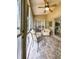 Relaxing enclosed patio with tiled floor, seating area, and access to the backyard at 3077 Branch, Clearwater, FL 33760