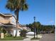Exterior view of townhouses with palm trees and a paved road at 3077 Branch, Clearwater, FL 33760