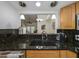Modern kitchen with dark granite countertops and stainless steel sink at 3077 Branch, Clearwater, FL 33760
