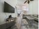 Spacious living room featuring hardwood floors, sectional sofa, and large TV at 3077 Branch, Clearwater, FL 33760