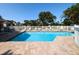 Community pool with lounge chairs and white fence at 3077 Branch, Clearwater, FL 33760