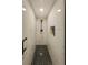 Modern shower with hexagon tile flooring and marble walls at 3077 Branch, Clearwater, FL 33760