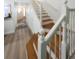 Elegant wooden staircase with white railings leading to the upper level at 3077 Branch, Clearwater, FL 33760