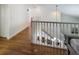 Upstairs hallway with hardwood floors and white railings at 3077 Branch, Clearwater, FL 33760
