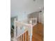 Upstairs hallway with hardwood floors and white railings at 3077 Branch, Clearwater, FL 33760