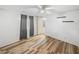 Spacious bedroom featuring ceiling fan and gray curtains at 37814 Daughtery Rd, Zephyrhills, FL 33541