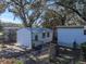 Detached garage with a metal roof and white siding at 37814 Daughtery Rd, Zephyrhills, FL 33541