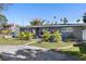 Gray house with palm trees and a long driveway at 4019 Helena Ne St, St Petersburg, FL 33703