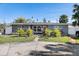 Gray house with palm trees and a long driveway at 4019 Helena Ne St, St Petersburg, FL 33703