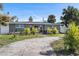 Gray house with palm trees and a long driveway at 4019 Helena Ne St, St Petersburg, FL 33703