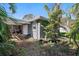 Rear view of a house with a gray exterior and a small yard at 4019 Helena Ne St, St Petersburg, FL 33703