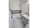 Tiled bathroom featuring a bathtub, toilet, vanity with sink, and neutral gray accents at 4735 22Nd N Ave, St Petersburg, FL 33713