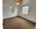 Bright bedroom featuring two windows, a ceiling fan, and patterned carpet at 4735 22Nd N Ave, St Petersburg, FL 33713