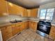 Kitchen featuring wooden cabinets, tile floor, and stainless steel stove at 4735 22Nd N Ave, St Petersburg, FL 33713