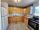 Kitchen featuring wooden cabinets, tile floor, stainless steel stove and white refrigerator at 4735 22Nd N Ave, St Petersburg, FL 33713