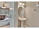 Powder room with pedestal sink and oval mirror at 4950 Pond Ridge Dr, Riverview, FL 33578