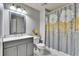 Bathroom with a shower/tub combo, gray vanity, and floral shower curtain at 4950 Pond Ridge Dr, Riverview, FL 33578