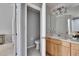 Bathroom with toilet and sink, light wood cabinets at 4950 Pond Ridge Dr, Riverview, FL 33578