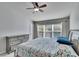 Bright bedroom featuring a floral bedspread and ample natural light at 4950 Pond Ridge Dr, Riverview, FL 33578
