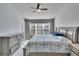 Spacious bedroom with a floral comforter and large windows at 4950 Pond Ridge Dr, Riverview, FL 33578