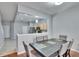 Bright dining room with kitchen view, hardwood floors, and a dark wood table at 4950 Pond Ridge Dr, Riverview, FL 33578
