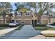 Tan three-story townhouse with two-car garage and landscaping at 4950 Pond Ridge Dr, Riverview, FL 33578