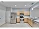 Modern kitchen with stainless steel appliances and light wood cabinets at 4950 Pond Ridge Dr, Riverview, FL 33578