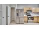 Kitchen with stainless steel appliances and light wood cabinets at 4950 Pond Ridge Dr, Riverview, FL 33578