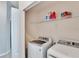 Laundry room with washer, dryer, and shelving at 4950 Pond Ridge Dr, Riverview, FL 33578